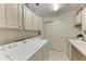 Functional laundry room with storage cabinets, washer, and dryer at 7710 Lake Vista Ct # 407, Lakewood Ranch, FL 34202