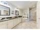 Bright, spacious main bathroom features a dual sink vanity, soaking tub, and marble walk-in shower at 7710 Lake Vista Ct # 407, Lakewood Ranch, FL 34202