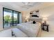 Main bedroom with sliding glass doors that lead to a balcony at 7710 Lake Vista Ct # 407, Lakewood Ranch, FL 34202