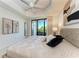 Main bedroom boasting balcony access, a ceiling fan, and neutral decor at 7710 Lake Vista Ct # 407, Lakewood Ranch, FL 34202