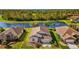 Aerial view of a single Gathering home with pond view surrounded by lush green landscaping at 8271 47Th Street E Cir, Palmetto, FL 34221