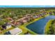 An aerial view showcasing the lakefront property surrounded by lush landscaping at 8271 47Th Street E Cir, Palmetto, FL 34221
