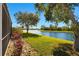 Expansive backyard with lush green lawn and serene water view, creating a peaceful outdoor space at 8271 47Th Street E Cir, Palmetto, FL 34221