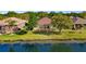 Beautiful backyard with water views from a screened in lanai and green grass at 8271 47Th Street E Cir, Palmetto, FL 34221