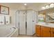 Bright bathroom featuring large corner shower, soaking tub and single sink at 8271 47Th Street E Cir, Palmetto, FL 34221
