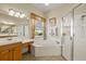 Bright bathroom with soaking tub, glass shower, and vanity at 8271 47Th Street E Cir, Palmetto, FL 34221