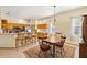 Cozy dining area with wood table and chairs, open to the kitchen, and tile flooring at 8271 47Th Street E Cir, Palmetto, FL 34221