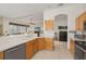 Well-lit kitchen with light wood cabinets, tile floors, and an open layout connecting to the living area at 8271 47Th Street E Cir, Palmetto, FL 34221