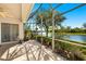 An enclosed lanai offers views of the lake, beautiful landscaping, and sunshine at 8271 47Th Street E Cir, Palmetto, FL 34221