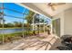 Relaxing screened lanai with ceiling fan overlooking a beautiful lake and landscaped backyard at 8271 47Th Street E Cir, Palmetto, FL 34221