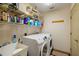 This laundry room features a washer and dryer and shelving for storage at 8271 47Th Street E Cir, Palmetto, FL 34221