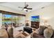 Bright and airy living room featuring fireplace, sliding doors to backyard, and an open floor plan at 8271 47Th Street E Cir, Palmetto, FL 34221