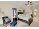 This main bedroom has a sitting area, ceiling fan, and ensuite bathroom at 8271 47Th Street E Cir, Palmetto, FL 34221