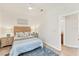 Comfortable bedroom featuring a ceiling fan, stylish decor, and access to an ensuite bathroom at 10072 Cozy Grove Dr, Venice, FL 34293