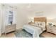 Cozy bedroom featuring a queen bed, soft lighting, and an area rug at 10072 Cozy Grove Dr, Venice, FL 34293