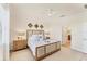 Light-filled bedroom with neutral decor, carpet, and access to the en-suite bathroom at 10072 Cozy Grove Dr, Venice, FL 34293