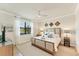 Serene bedroom with a neutral color scheme, large window, and carpet at 10072 Cozy Grove Dr, Venice, FL 34293