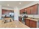 Spacious kitchen with stainless steel appliances, granite countertops, and ample cabinetry at 10072 Cozy Grove Dr, Venice, FL 34293