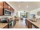 Well-equipped kitchen with stainless steel appliances, granite counters, and open layout to living area at 10072 Cozy Grove Dr, Venice, FL 34293