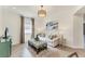 Cozy living room with neutral décor, large window, and stylish furnishings at 10072 Cozy Grove Dr, Venice, FL 34293