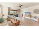 Inviting living room featuring neutral decor, tile floors, and sliding glass doors to the outdoors at 10072 Cozy Grove Dr, Venice, FL 34293