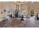 Elegant lobby area with high ceilings, tiled floors, and stylish decor at 10072 Cozy Grove Dr, Venice, FL 34293