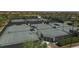 Aerial view of community tennis courts with individual shade pavilions for the players at 10072 Cozy Grove Dr, Venice, FL 34293