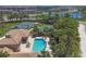 Aerial view of community amenities featuring swimming pool, tennis and basketball courts, and lake views at 1021 Ancora Blvd, North Venice, FL 34275