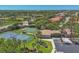 Aerial view of community amenities featuring tennis and basketball courts with surrounding lush tropical landscaping at 1021 Ancora Blvd, North Venice, FL 34275