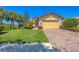 Lovely single-Gathering home with a two-car garage, well-maintained lawn, and paver driveway at 1021 Ancora Blvd, North Venice, FL 34275