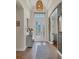 Inviting foyer with decorative front door, transom window, light fixture, and tile flooring at 1021 Ancora Blvd, North Venice, FL 34275