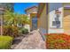 Landscaped walkway leads to the home's front entrance with a decorative door and visible house number at 1021 Ancora Blvd, North Venice, FL 34275