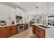 Modern kitchen featuring two-tone cabinetry, stainless steel appliances, and seamless transition to dining area at 1021 Ancora Blvd, North Venice, FL 34275