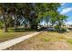 Mature trees and manicured lawn lead to waterfront access at 108 Martin Ne Dr, Port Charlotte, FL 33952