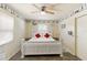 Bright bedroom with white furniture, ceiling fan, and decor featuring coastal designs at 108 Martin Ne Dr, Port Charlotte, FL 33952