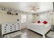 Bright bedroom with white furniture, ceiling fan, and decor featuring coastal designs at 108 Martin Ne Dr, Port Charlotte, FL 33952