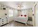 Bright bedroom with white furniture, ceiling fan, and decor featuring coastal designs at 108 Martin Ne Dr, Port Charlotte, FL 33952