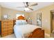 Bedroom featuring warm-toned walls, light colored tile, and a large wooden bed frame at 108 Martin Ne Dr, Port Charlotte, FL 33952