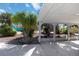 View of the carport with a concrete floor and tropical landscaping at 108 Martin Ne Dr, Port Charlotte, FL 33952