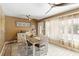 Dining area with wood table, seating for six, and ample natural light through large window at 108 Martin Ne Dr, Port Charlotte, FL 33952