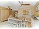 Well-lit dining room with hardwood floors, bench seating and stylish light fixtures at 108 Martin Ne Dr, Port Charlotte, FL 33952