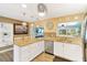Bright eat-in kitchen with stainless steel appliances, white cabinetry and gorgeous stone countertops at 108 Martin Ne Dr, Port Charlotte, FL 33952