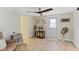 Bright living room with driftwood accents, wood flooring, and modern ceiling fan at 108 Martin Ne Dr, Port Charlotte, FL 33952