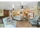Comfortable living room featuring two ceiling fans, light walls, and barn door to adjacent space at 108 Martin Ne Dr, Port Charlotte, FL 33952