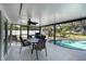 Covered patio with dining set next to sparkling screened-in pool area at 108 Martin Ne Dr, Port Charlotte, FL 33952