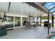 Covered patio with a dining set, grill, and access to the pool area ideal for outdoor entertaining at 108 Martin Ne Dr, Port Charlotte, FL 33952