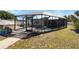 Enclosed pool area with a caged enclosure offering privacy and protection from the elements at 108 Martin Ne Dr, Port Charlotte, FL 33952