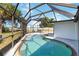 Sparkling pool with screen enclosure overlooks backyard, offering a private oasis at 108 Martin Ne Dr, Port Charlotte, FL 33952