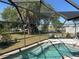 Relaxing screened-in pool area with lush backyard and lovely water view at 108 Martin Ne Dr, Port Charlotte, FL 33952