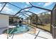 Sparkling pool with sun deck inside screened in area and dining set at 108 Martin Ne Dr, Port Charlotte, FL 33952